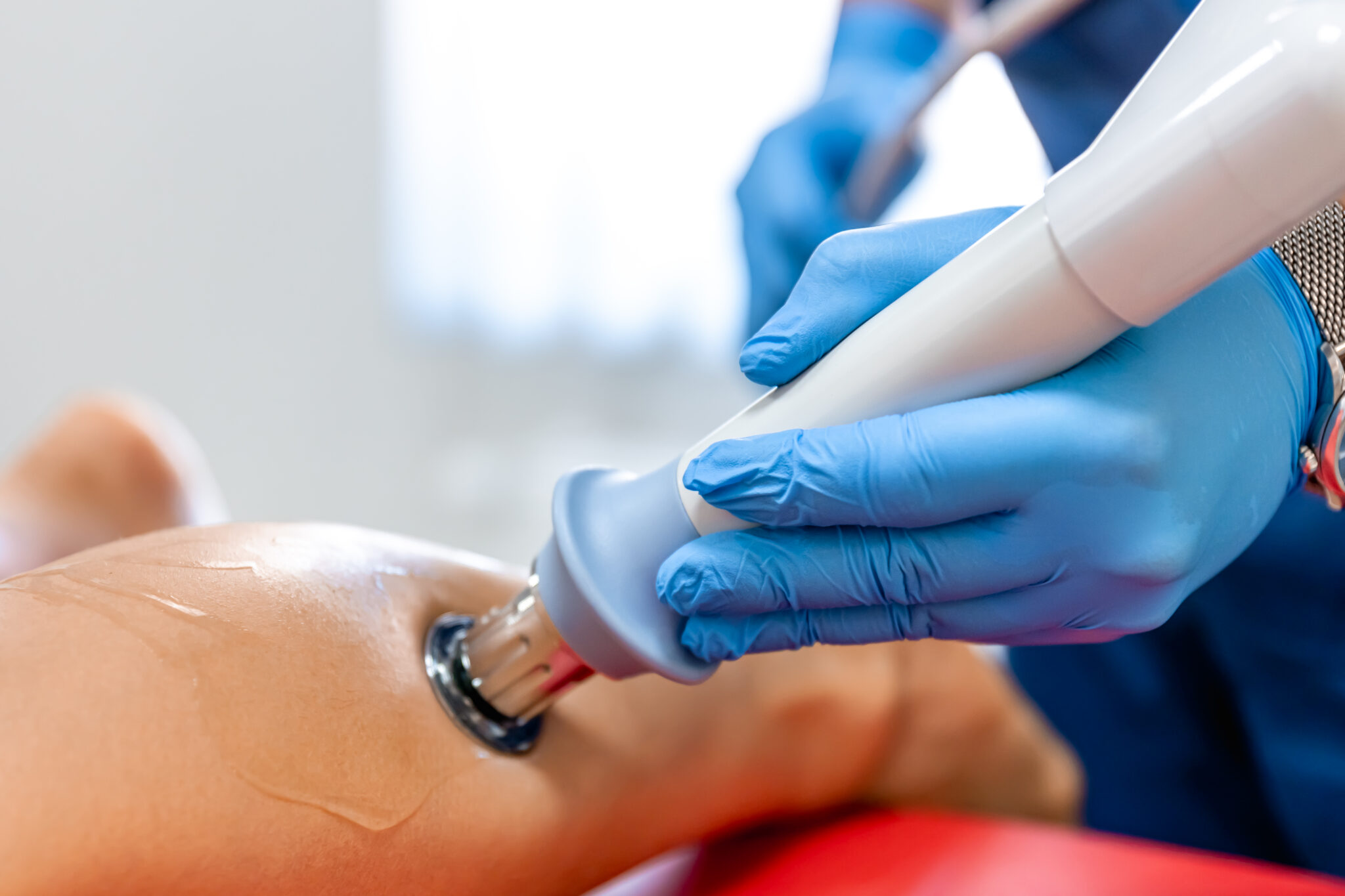 Physiotherapist Administering Shockwave Treatment on Lower Leg at Pinehill Physio